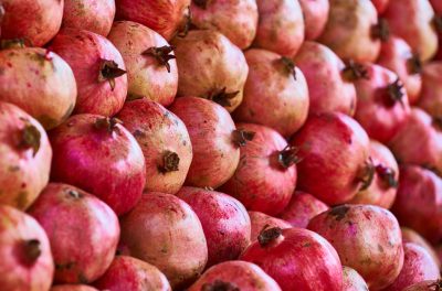 pexels-photo-3084219-3084219 Close-up view of vibrant and ripe pomegranates displaying their organic texture and rich red colors.
